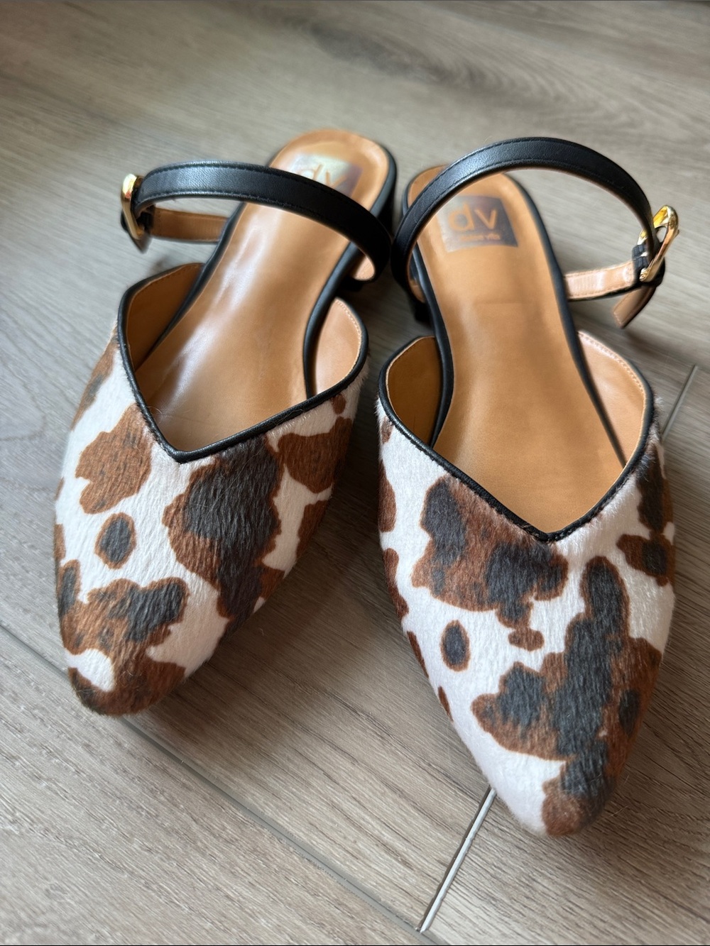 Cow print slip on flats